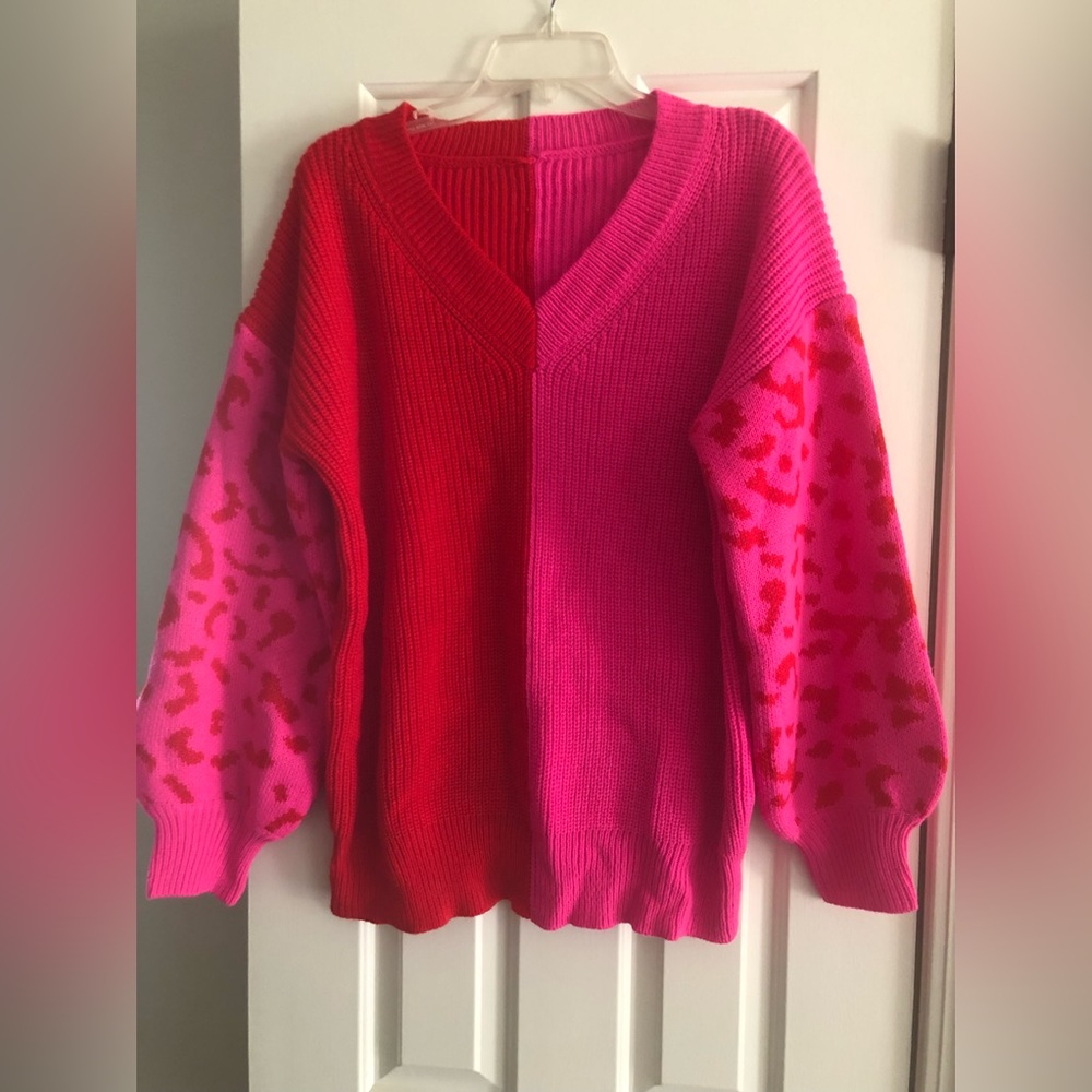 Pink & Red sweater with leopard print sleeves.